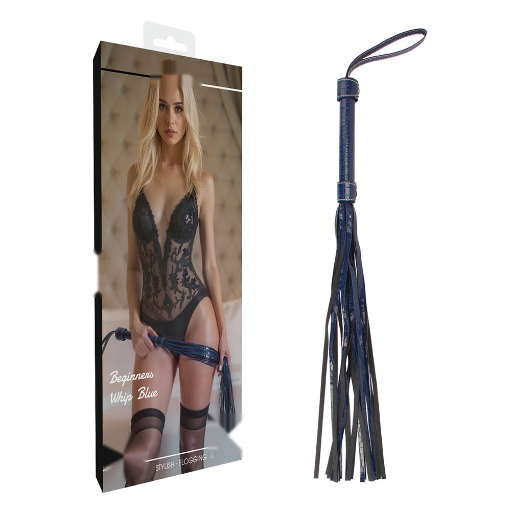 A dark blue flogger with a leather handle and multi-strand tassel, shown next to its retail packaging box on a plain white background.
