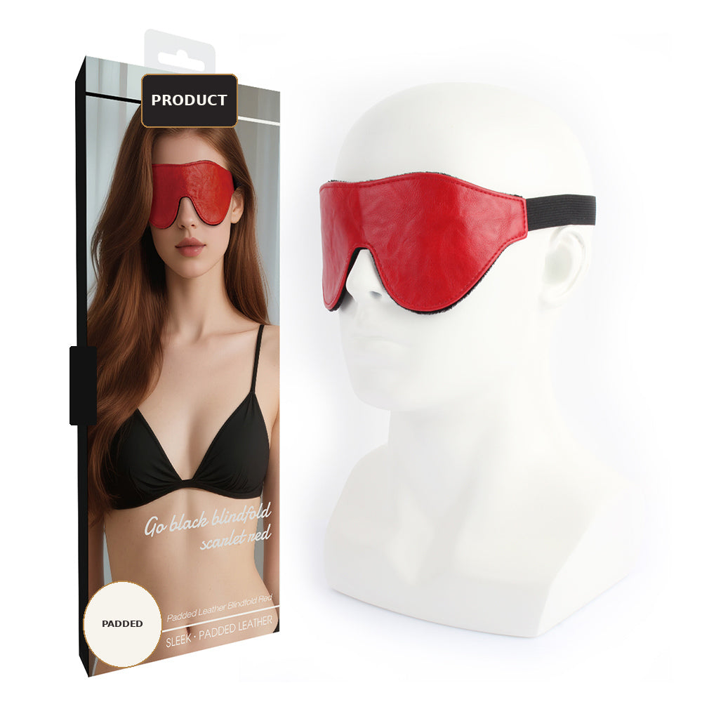 Red padded blindfold eye mask displayed on a white mannequin head next to its retail packaging box, which features a model wearing the mask.
