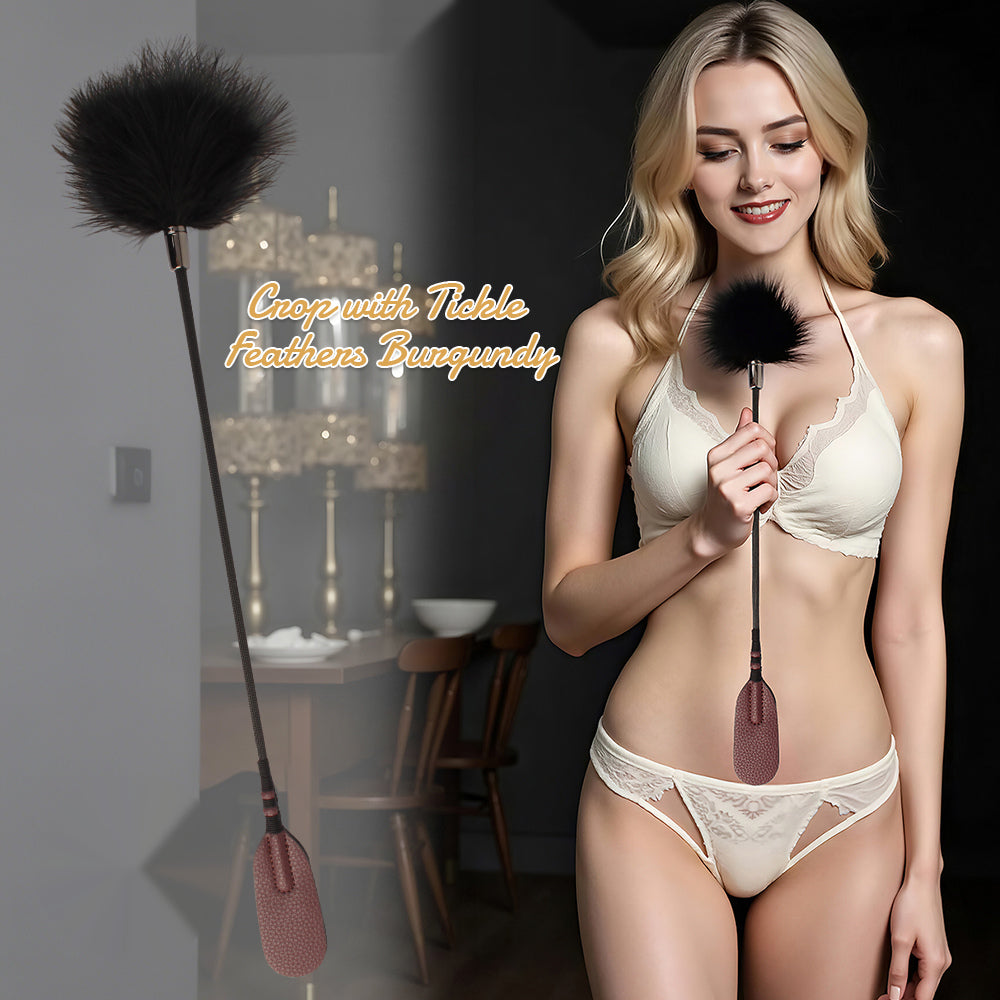A woman in cream lace lingerie holds a feather duster-style personal care tool with a black feather head and a pink handle. A larger inset on the left shows the full product against a dark interior background, with overlaid text reading 'Cape with Tinsel Feathers Burgundy.