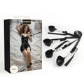Black under-bed restraint system with cuffs, straps and silver hardware beside product packaging