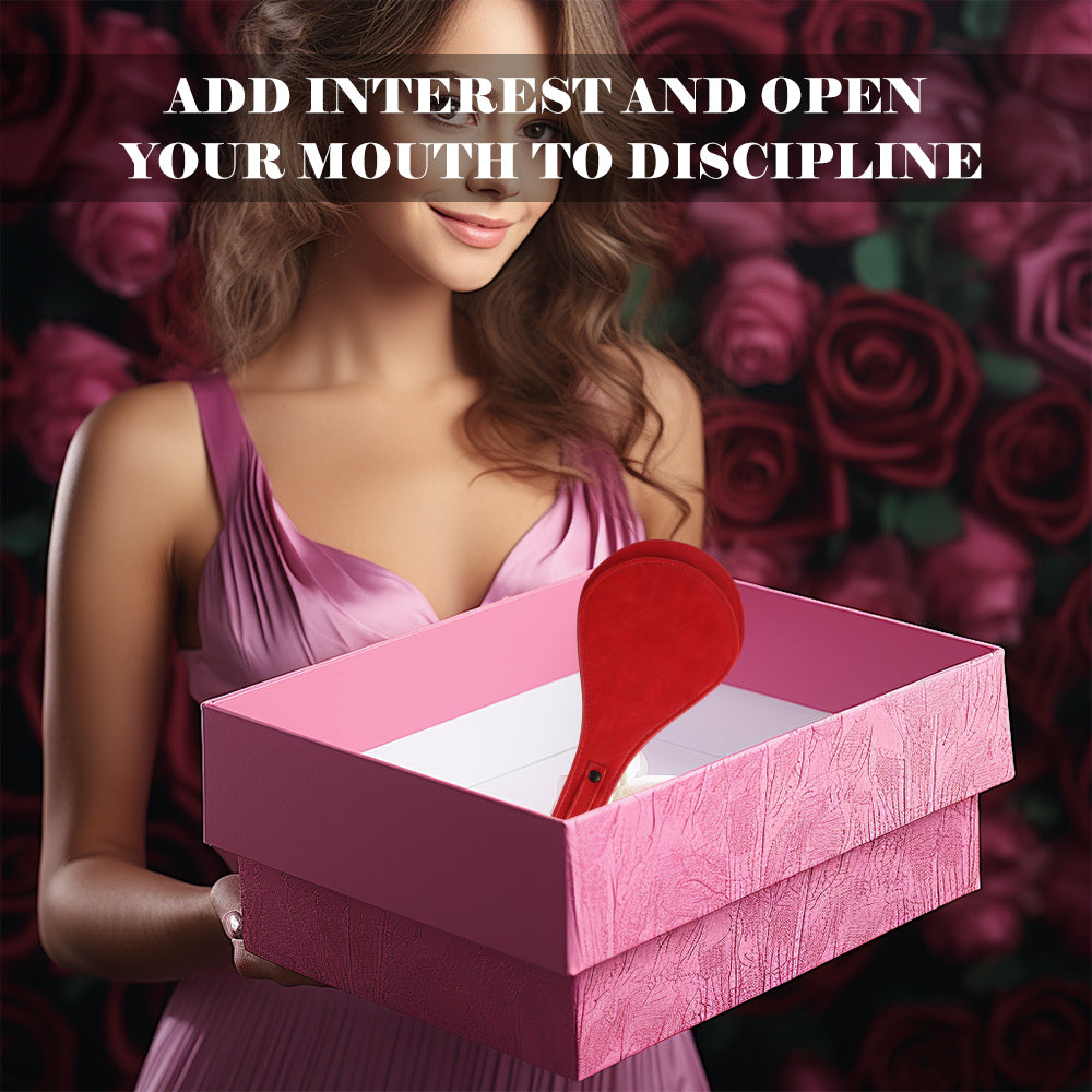 Scarlet round leather paddle presented in a pink gift box against a dark rose background.
