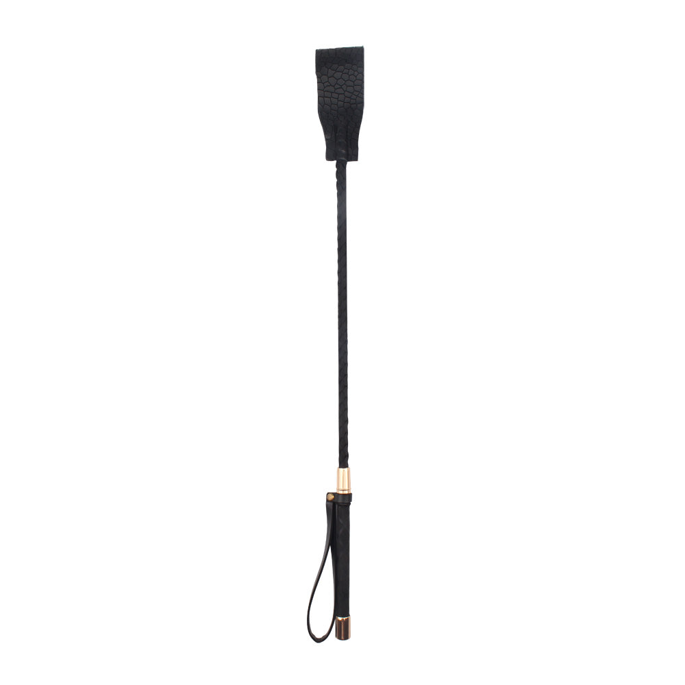 A black leather riding crop with a textured handle, a black wrapped grip, and gold-toned metal accents, shown against a plain white background.
