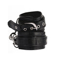 Pair of black adjustable padded wrist cuffs with silver-tone metal rings and hardware on a white background