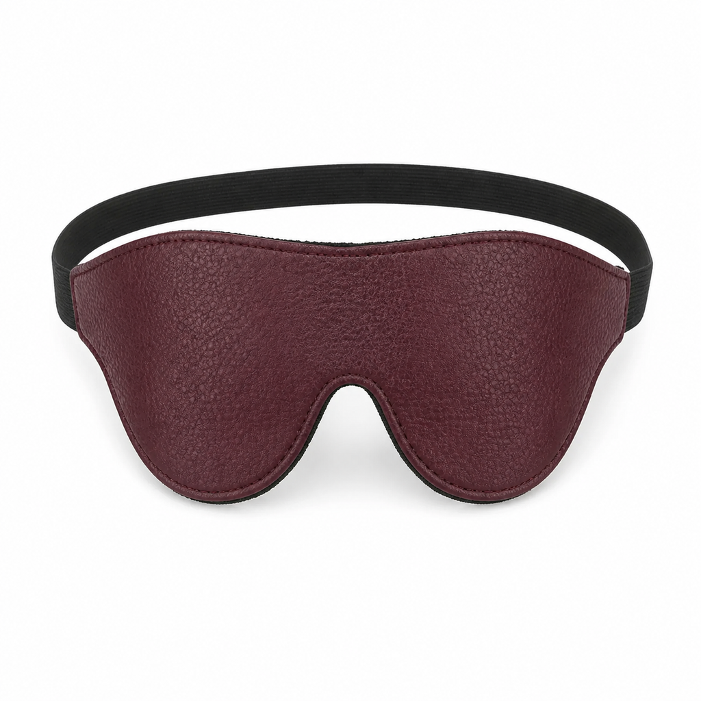 Burgundy padded blindfold with adjustable elastic strap on a clean white background.
