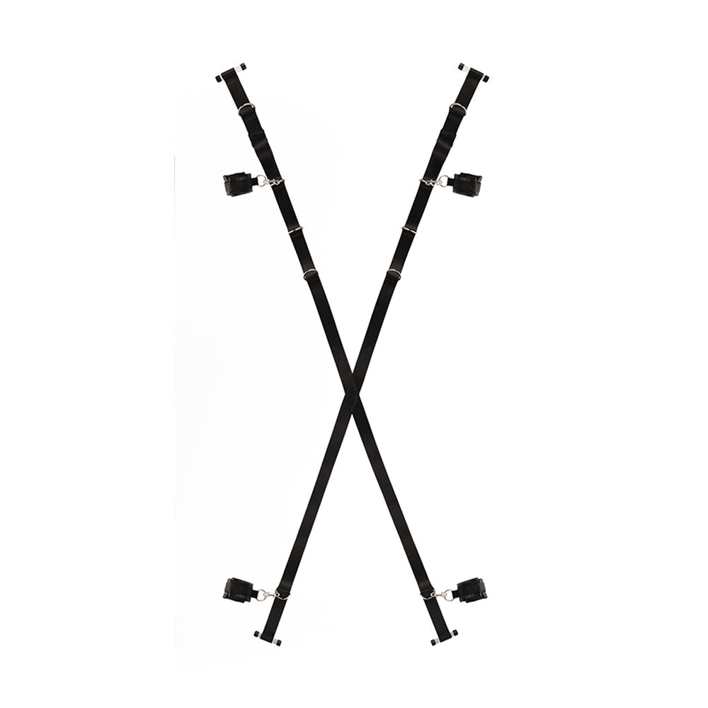 Black over-the-door restraint system with two straps and four padded cuffs on white.
